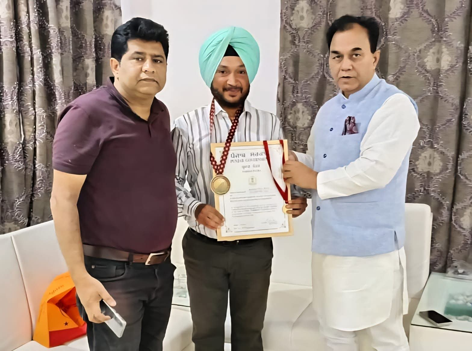 Cyclist Balraj Singh Chauhan receives special honour from Lok Sabha MP Dr. Raj Kumar.